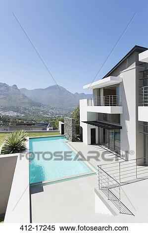 Modern house and swimming pool with mountain view View Large Photo Image Stock Photography - Modern house and swimming pool with mountain view. Fotosearch