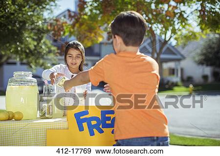 Boy buying lemonade at lemonade stand View Large Photo Image Stock Photo - Boy buying lemonade at lemonade stand. Fotosearch