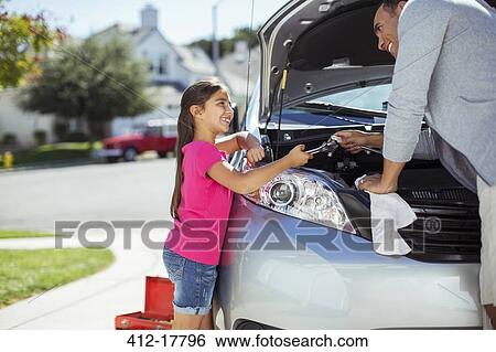 Father and daughter fixing car engine View Large Photo Image Stock Photograph - Father and daughter fixing car engine. Fotosearch