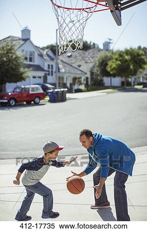 Father and son playing basketball in driveway View Large Photo Image Stock Photography - Father and son playing basketball in driveway. Fotosearch