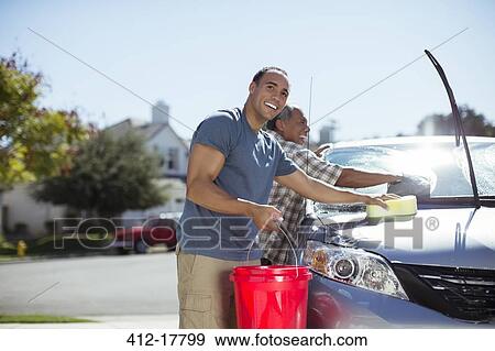 Stock Photo - Father and son washing car in driveway. Fotosearch