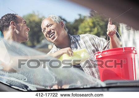Father and son washing car View Large Photo Image Stock Image - Father and son washing car. Fotosearch