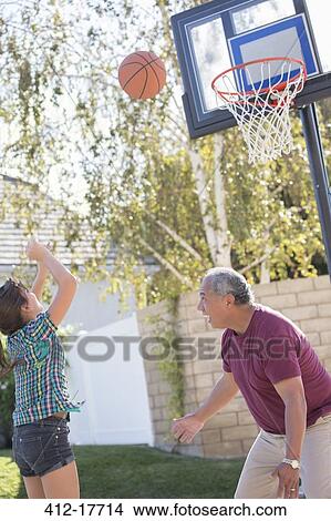 Grandfather and granddaughter playing basketball View Large Photo Image Picture - Grandfather and granddaughter playing basketball. Fotosearch
