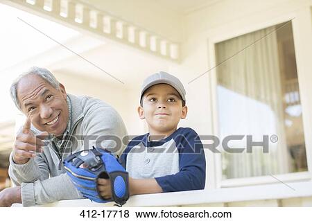 Grandfather and grandson with baseball glove on porch View Large Photo Image Stock Photo - Grandfather and grandson with baseball glove on porch. Fotosearch