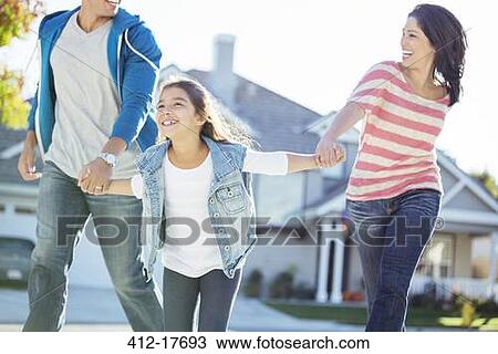 Stock Image - Happy family holding hands and running. Fotosearch