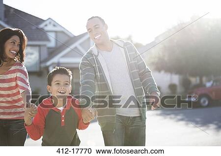 Happy family running on sunny street View Large Photo Image Stock Image - Happy family running on sunny street. Fotosearch