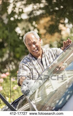 Happy man washing car View Large Photo Image Stock Photo - Happy man washing car. Fotosearch