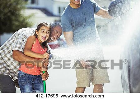 Multi-generation family washing car View Large Photo Image Stock Photography - Multi-generation family washing car. Fotosearch