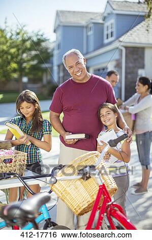 Portrait of grandfather and granddaughter at yard sale View Large Photo Image Stock Photograph - Portrait of grandfather and granddaughter at yard sale. Fotosearch