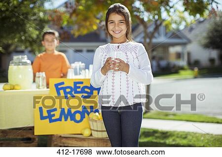 Portrait of smiling girl at lemonade stand View Large Photo Image Stock Photo - Portrait of smiling girl at lemonade stand. Fotosearch