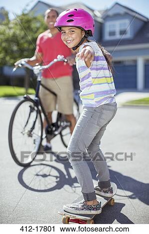 Portrait of smiling girl on skateboard View Large Photo Image Stock Image - Portrait of smiling girl on skateboard. Fotosearch