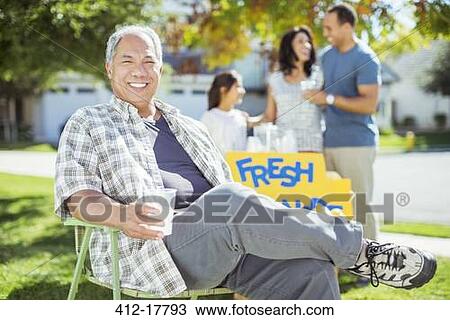 Portrait of smiling man drinking lemonade near lemonade stand View Large Photo Image Stock Image - Portrait of smiling man drinking lemonade near lemonade stand. Fotosearch