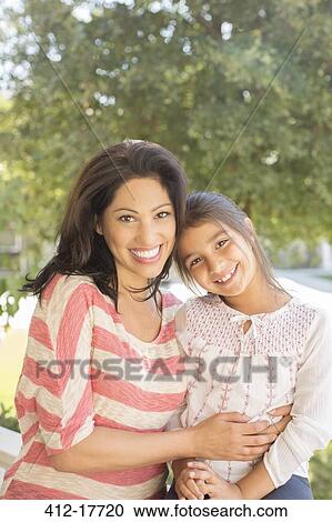 Stock Image - Portrait of smiling mother and daughter. Fotosearch
