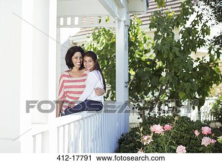 Portrait of smiling mother and daughter on porch View Large Photo Image Stock Image - Portrait of smiling mother and daughter on porch. Fotosearch