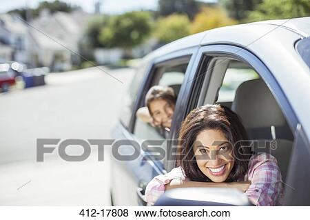 Portrait of smiling mother and daughter in car View Large Photo Image Stock Photo - Portrait of smiling mother and daughter in car. Fotosearch