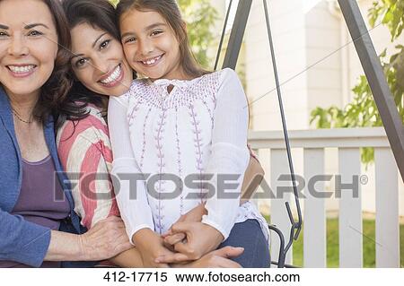 Stock Photography - Portrait of smiling multi-generation women. Fotosearch