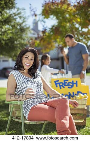 Picture - Portrait of smiling woman at lemonade stand. Fotosearch