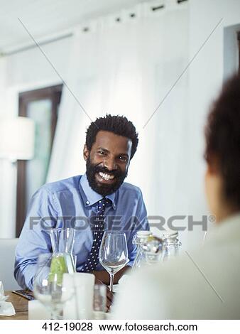 Stock Photo - Couple eating together at table. Fotosearch