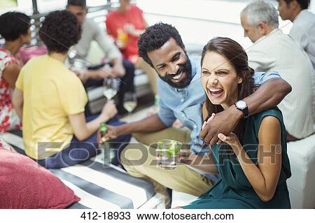 Couple hugging at party View Large Photo Image Stock Image - Couple hugging at party. Fotosearch
