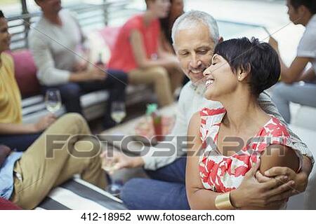 Couple hugging at party View Large Photo Image Stock Image - Couple hugging at party. Fotosearch