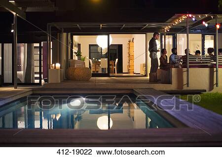 Empty pool in backyard of modern house View Large Photo Image Stock Image - Empty pool in backyard of modern house. Fotosearch