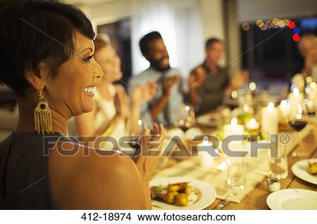 Friends applauding at dinner party View Large Photo Image Picture - Friends applauding at dinner party. Fotosearch