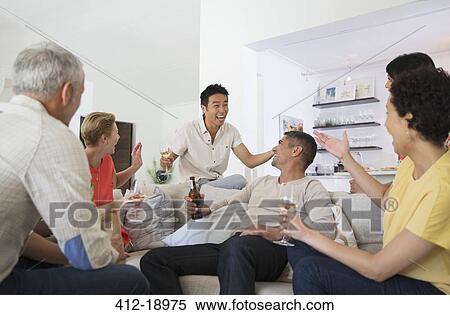 Friends cheering at party View Large Photo Image Stock Photography - Friends cheering at party. Fotosearch