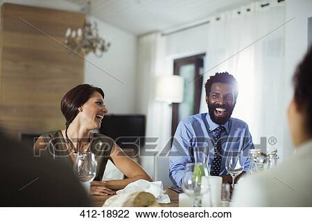 Friends laughing at dinner party View Large Photo Image Stock Image - Friends laughing at dinner party. Fotosearch