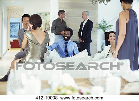 Friends relaxing at party View Large Photo Image Stock Photo - Friends relaxing at party. Fotosearch