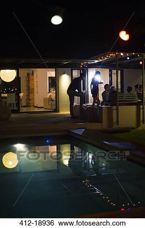 Friends relaxing at party View Large Photo Image Stock Photograph - Friends relaxing at party. Fotosearch