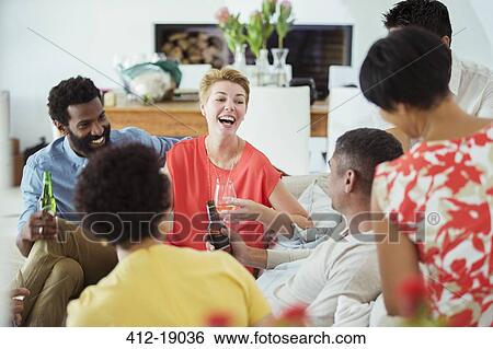 Friends relaxing at party View Large Photo Image Stock Photograph - Friends relaxing at party. Fotosearch