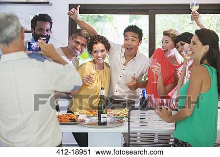 Friends taking picture together at party View Large Photo Image Stock Image - Friends taking picture together at party. Fotosearch