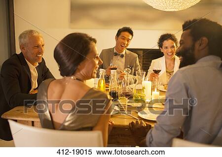 Stock Photography - Friends talking at dinner party. Fotosearch