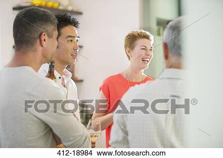 Picture - Friends talking at party. Fotosearch
