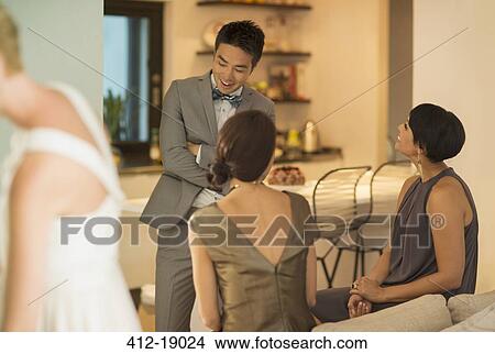 Friends talking at party View Large Photo Image Picture - Friends talking at party. Fotosearch