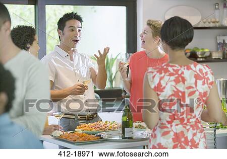 Friends talking at party View Large Photo Image Stock Image - Friends talking at party. Fotosearch