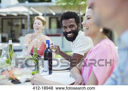 Stock Photo - Friends talking at party. Fotosearch