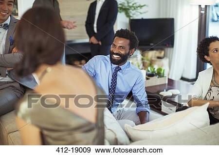 Friends talking at party View Large Photo Image Stock Photo - Friends talking at party. Fotosearch