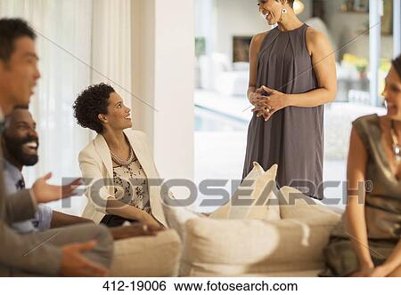 Friends talking at party View Large Photo Image Stock Photograph - Friends talking at party. Fotosearch