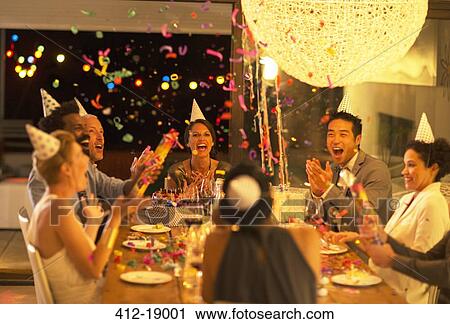 Friends throwing confetti at birthday party View Large Photo Image Stock Image - Friends throwing confetti at birthday party. Fotosearch