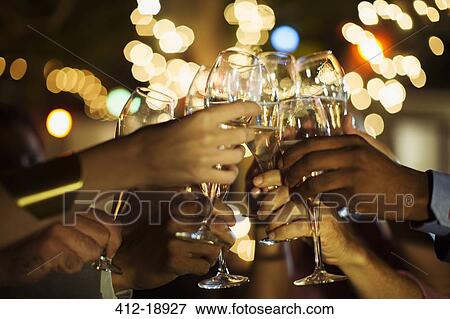 Friends toasting each other at party View Large Photo Image Stock Photo - Friends toasting each other at party. Fotosearch