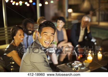 Man laughing at party View Large Photo Image Stock Image - Man laughing at party. Fotosearch