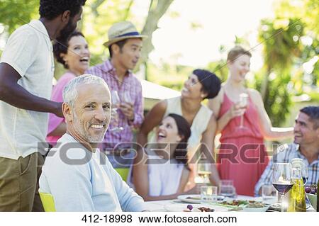 Man smiling at party outdoors View Large Photo Image Stock Photo - Man smiling at party outdoors. Fotosearch