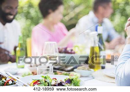 Plates of food on table outdoors View Large Photo Image Stock Photo - Plates of food on table outdoors. Fotosearch