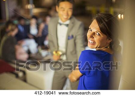 Stock Image - Woman laughing at party. Fotosearch
