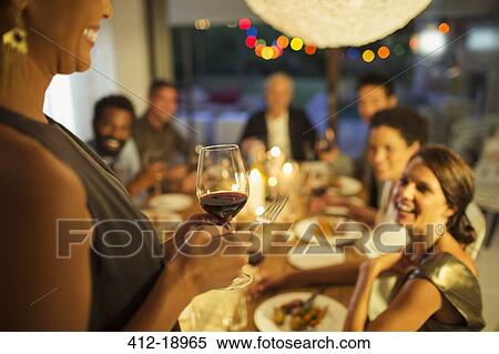 Stock Photography - Woman proposing a toast at party. Fotosearch