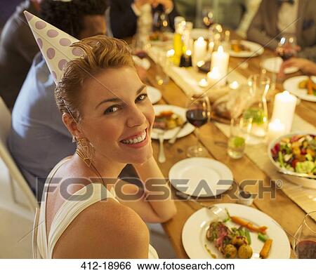Woman smiling at birthday party View Large Photo Image Stock Photograph - Woman smiling at birthday party. Fotosearch