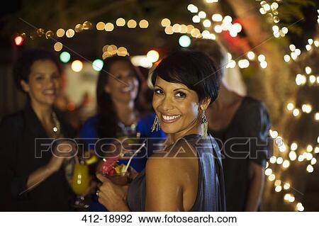 Woman smiling at party View Large Photo Image Stock Image - Woman smiling at party. Fotosearch