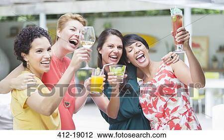 Women cheering together at party View Large Photo Image Stock Image - Women cheering together at party. Fotosearch
