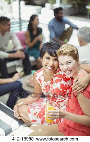 Women hugging at party View Large Photo Image Stock Photo - Women hugging at party. Fotosearch